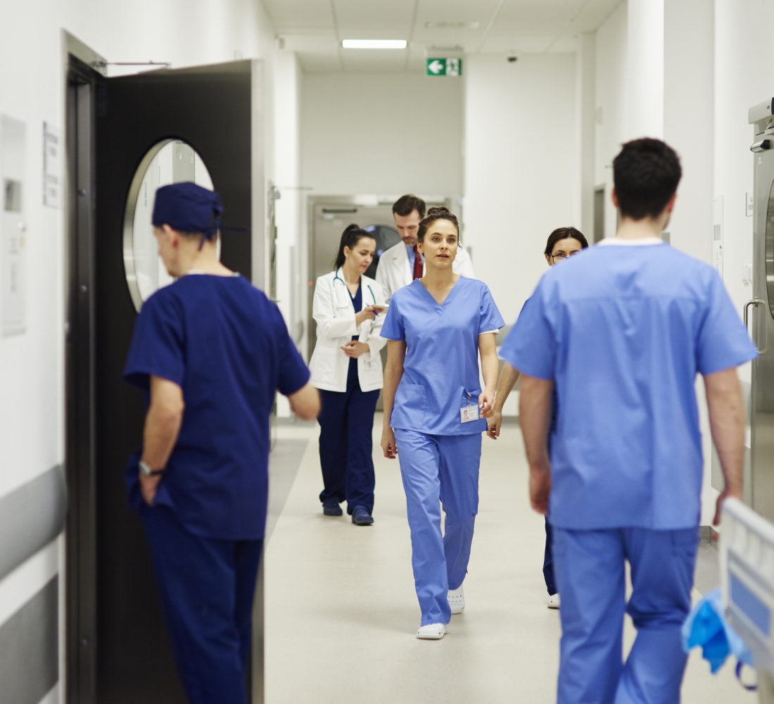 Doctors walking through corridor in hospital